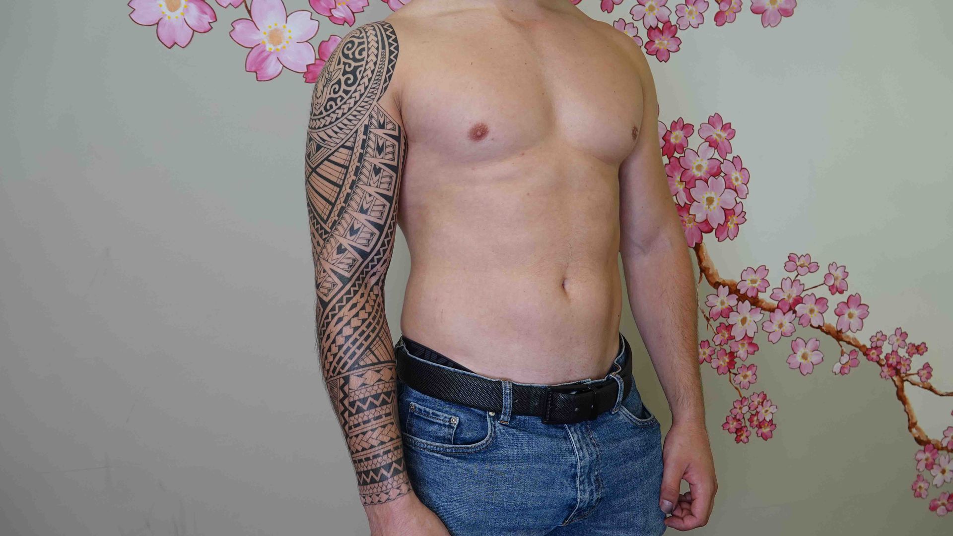 Zwarte maori-mouw over arm en zij van een man